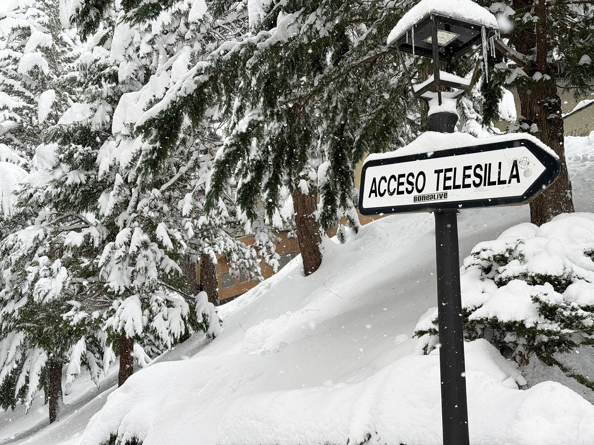 verschneite Landschaft mit Schild für Skilift