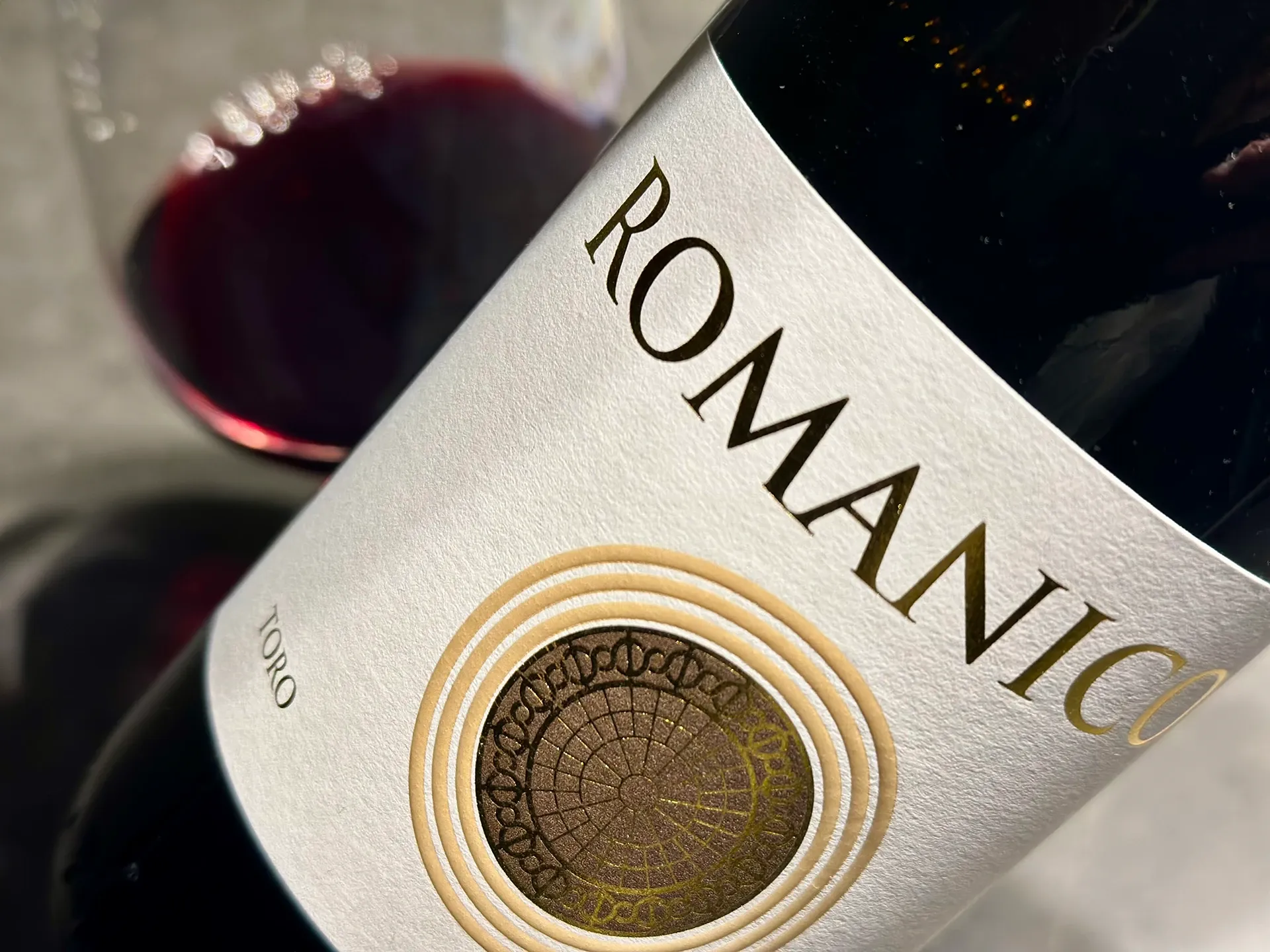 Rotweinflasche mit der Aufschrift Romanico mit Glas